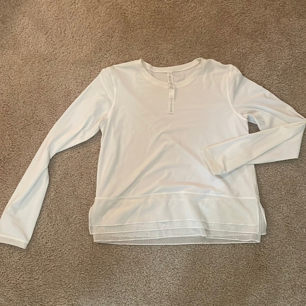White Lululemon long sleeve shirt with mesh at the bottom